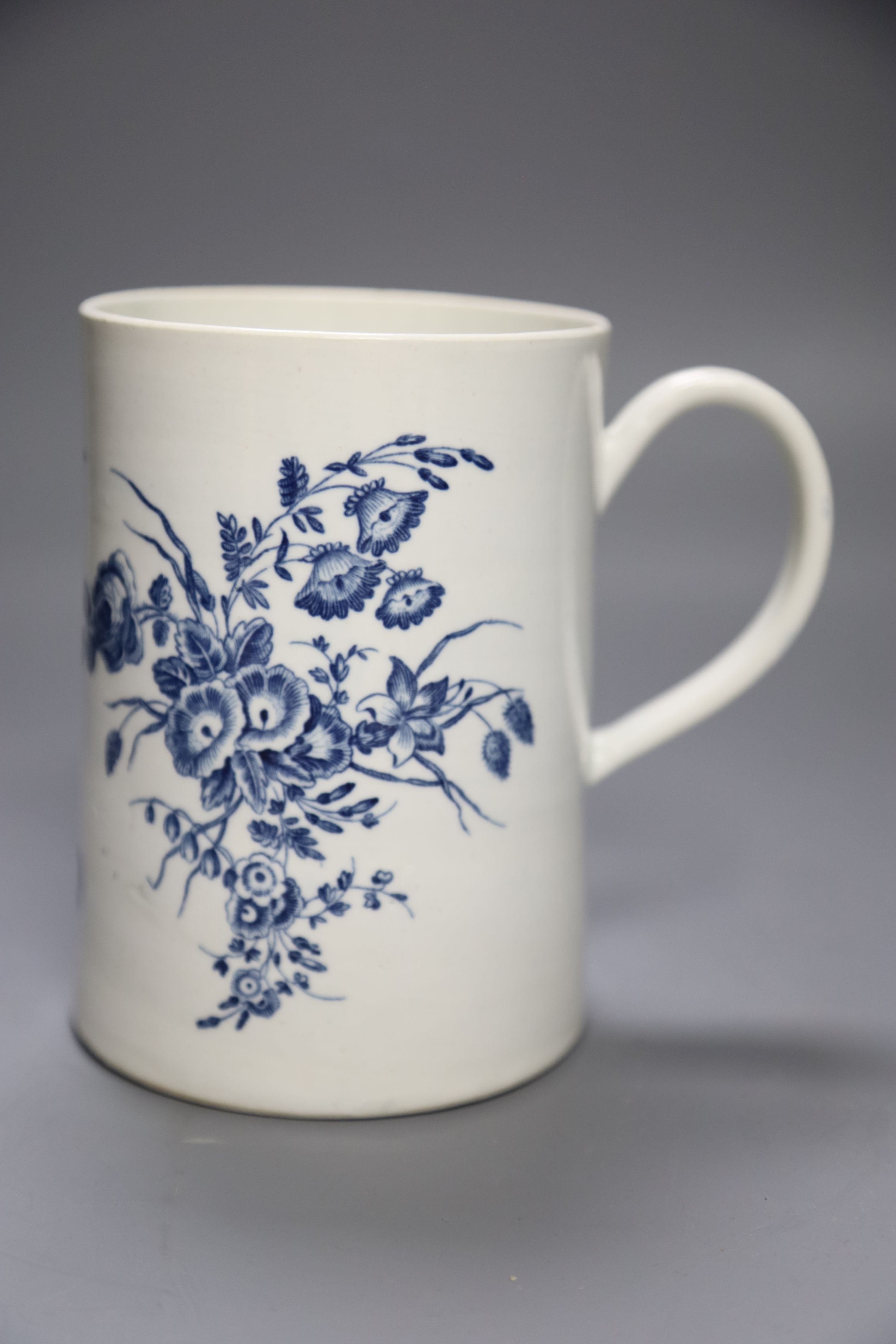 A Worcester cylindrical mug decorated in blue under glaze two large floral sprays, height 14cm